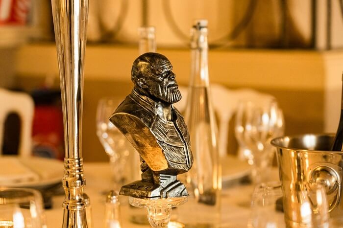 The purple giant Thanos, famous in the Marvel universe, is being prepared for the wedding party by the bride and groom.