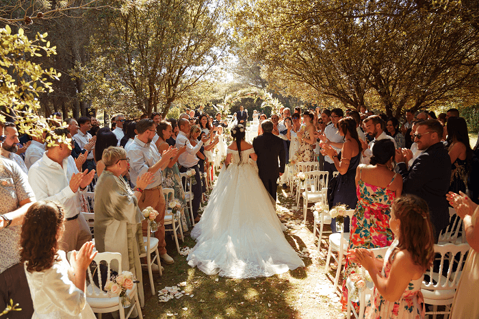 The moment Lydie takes the arm of her beloved father and walks into the church.