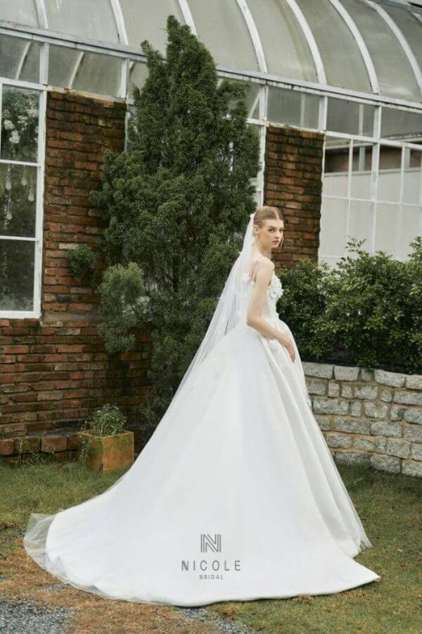 The girl looks sweet and gentle in Emma wedding dress